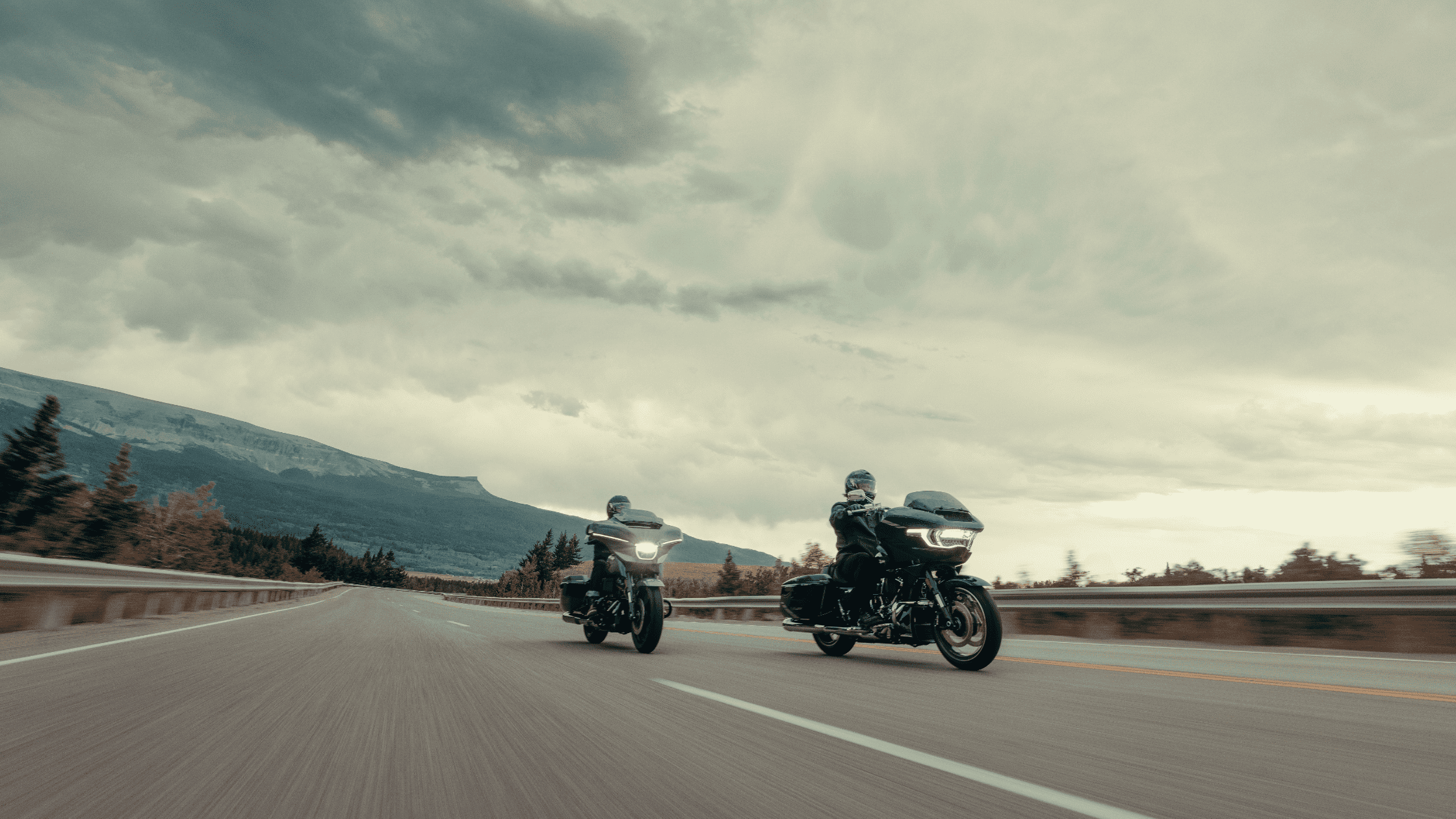 Two Grand American Touring Harley-Davidson® motorcycles cruising on the road, part of the MY2025 lineup available at Space Coast Harley-Davidson®