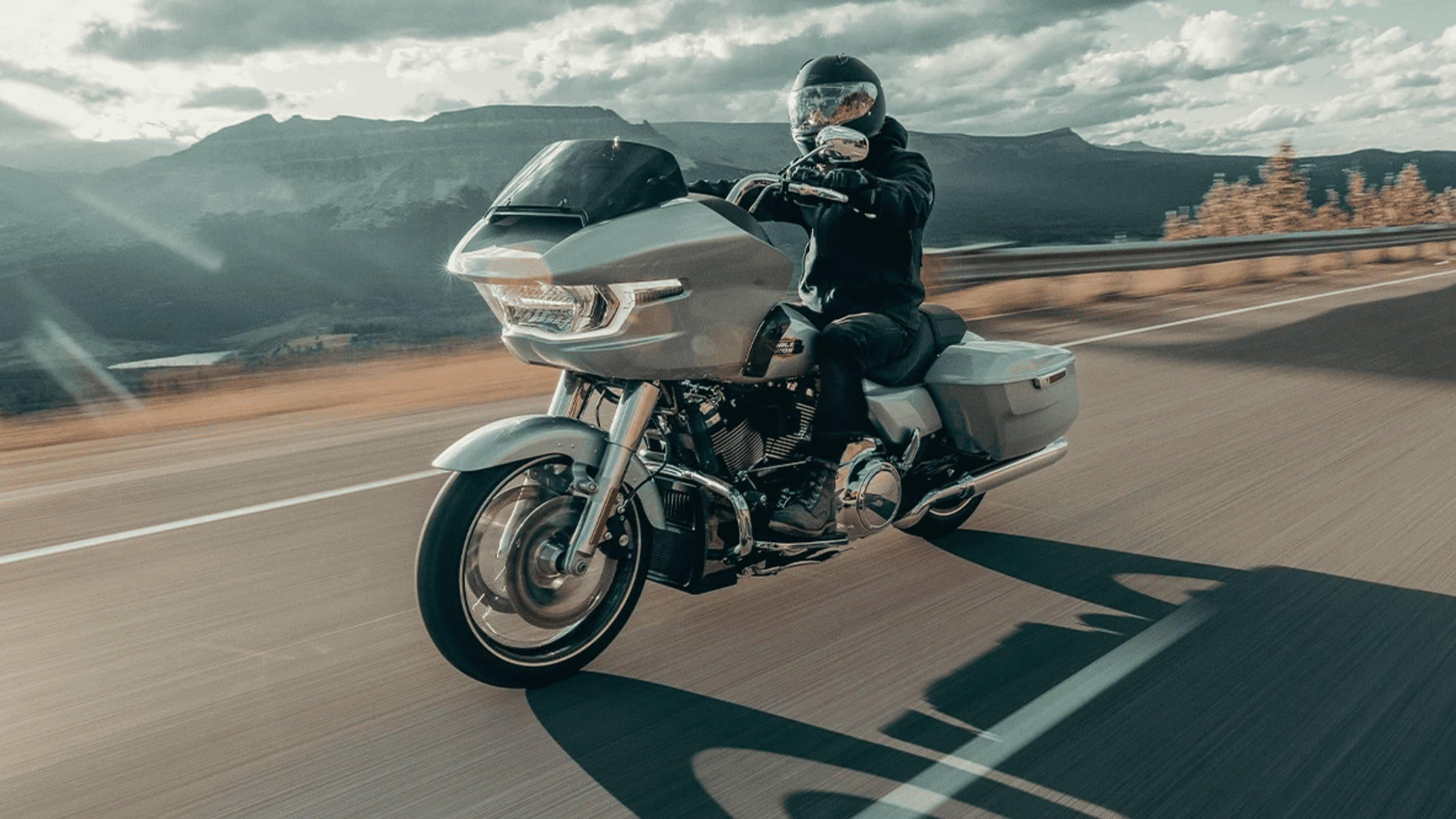 A person riding a 2025 Harley-Davidson® Road Glide® motorcycle on a highway near Orlando, FL, showcasing freedom and adventure. Available at Space Coast Harley-Davidson® 