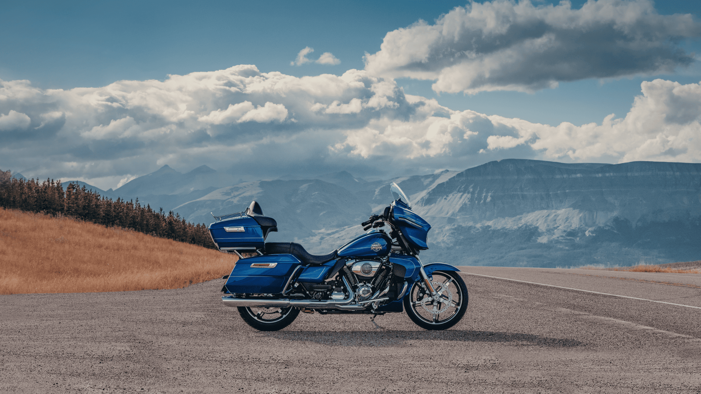 A blue 2025 Harley-Davidson® Street Glide® Ultra parked on the roadside near Orlando, FL, available…