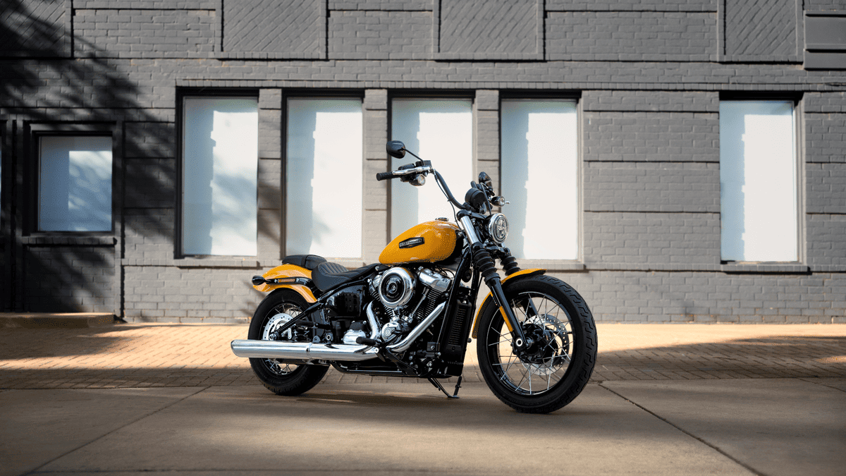 2025 Harley-Davidson® Street Bob® parked in front of brick building near Sanford, FL in a bold yellow finish
