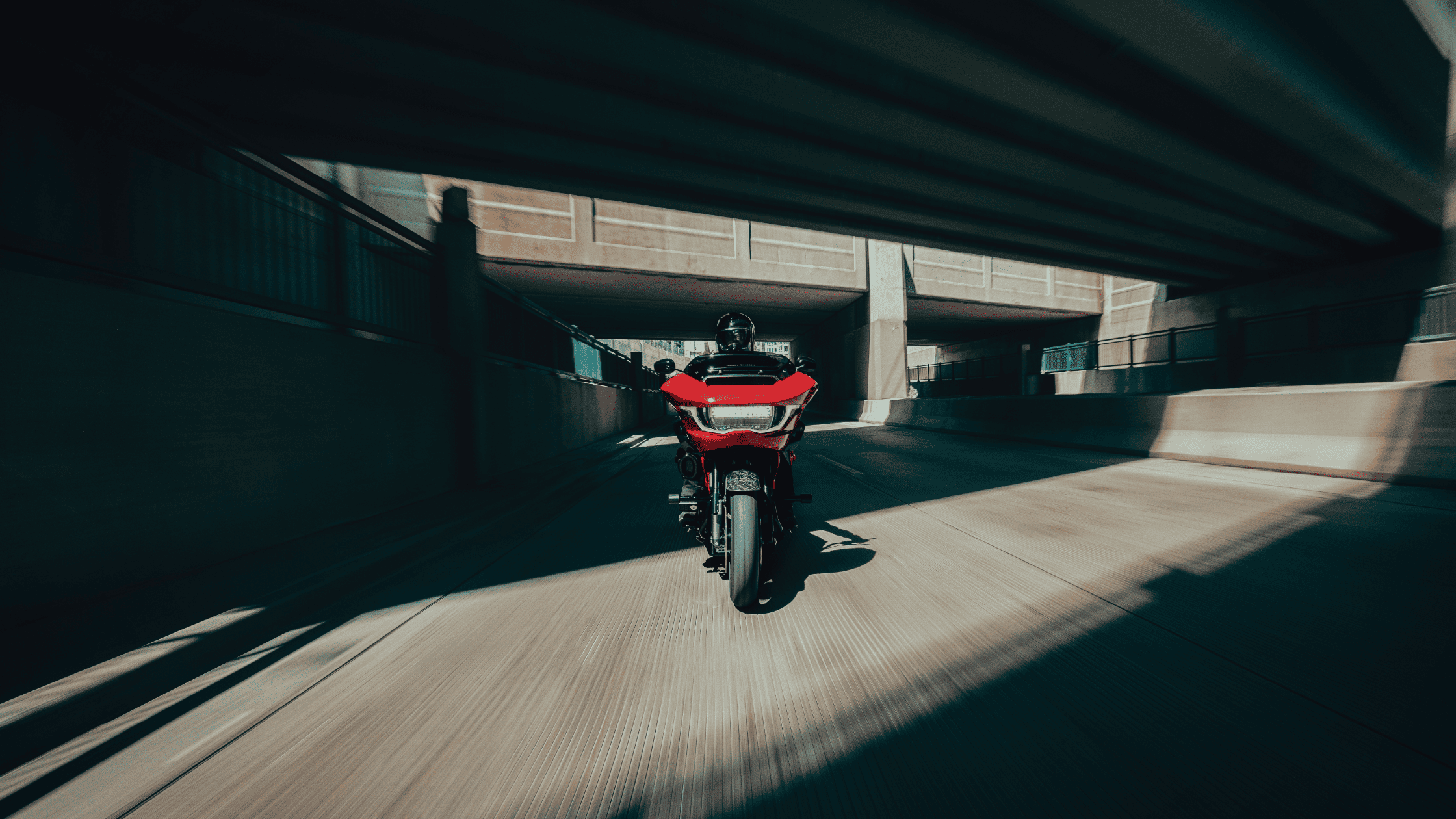 Front view of red 2025 Harley-Davidson CVO Road Glide ST speeding through underpass near Sanford, FL