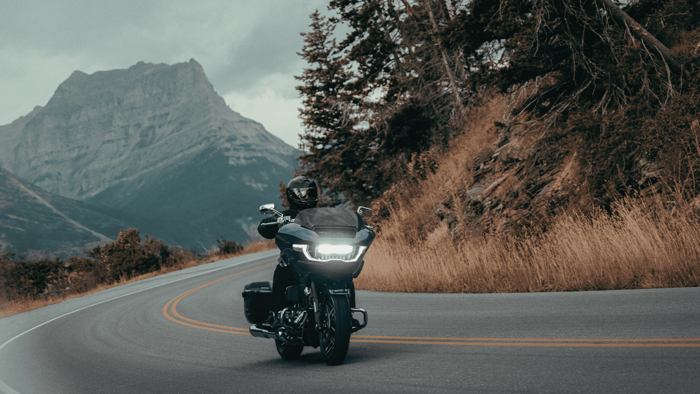 2025 Harley-Davidson CVO Road Glide riding on a scenic mountain curve near Sanford, FL with LED headlight on