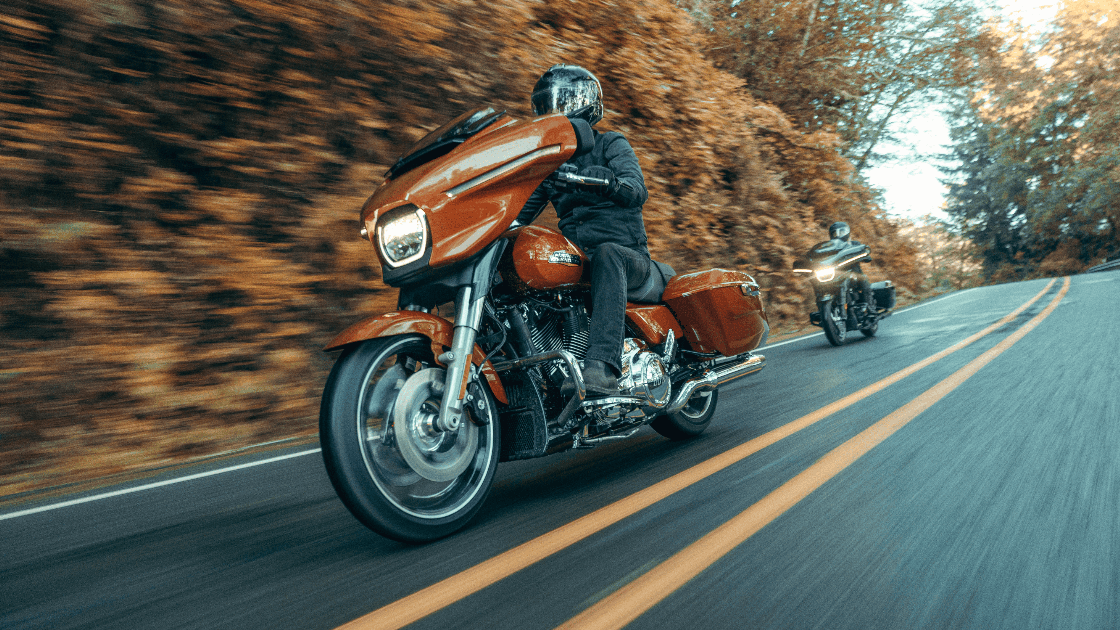 Two riders on 2025 Harley-Davidson® Street Glide® motorcycles cruising down a road near Sanford, FL.