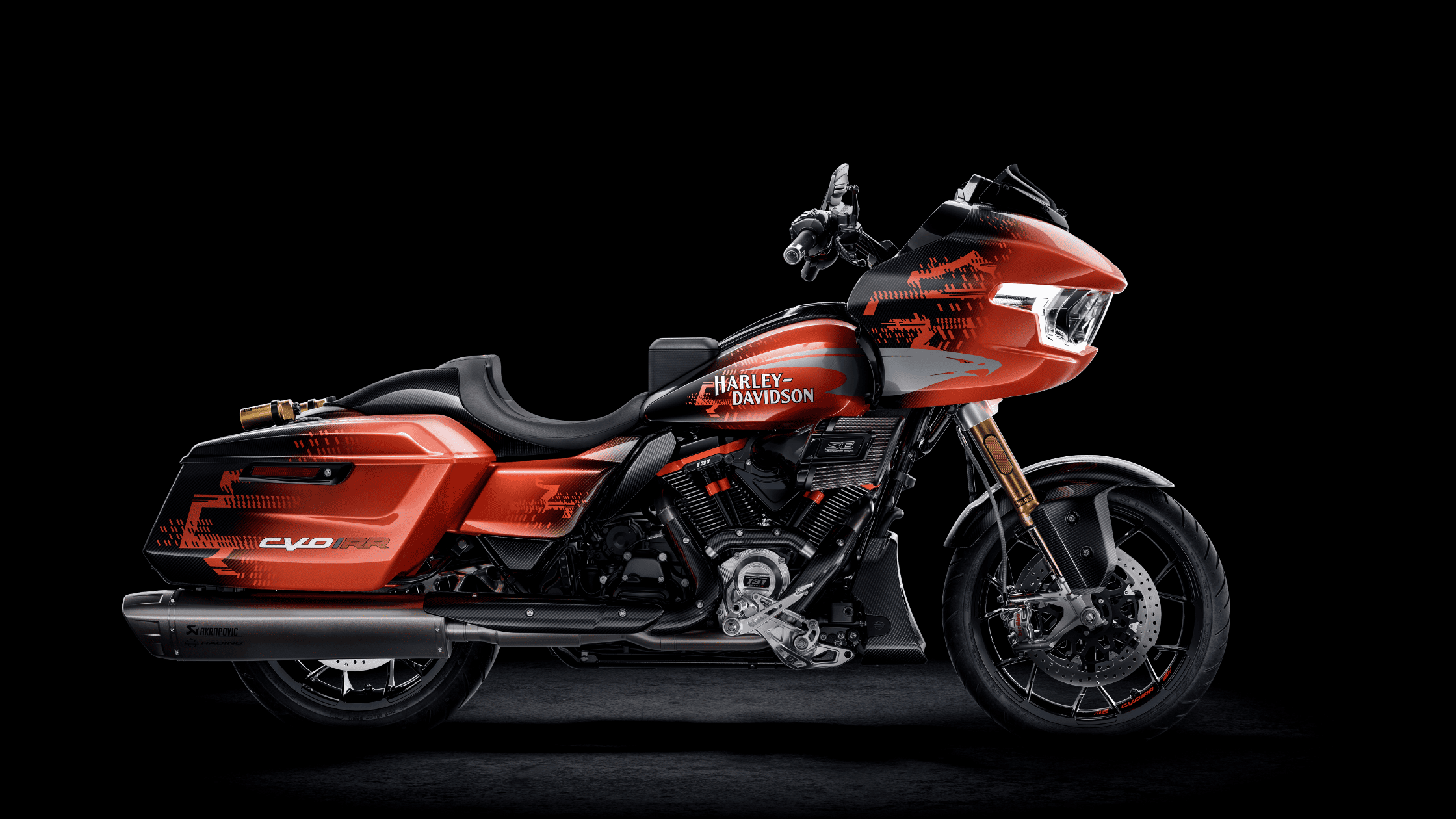 A vibrant red 2025 Harley-Davidson® CVO™ Road Glide® RR motorcycle set against a dark black backdrop. Available at Space Coast Harley-Davidson®